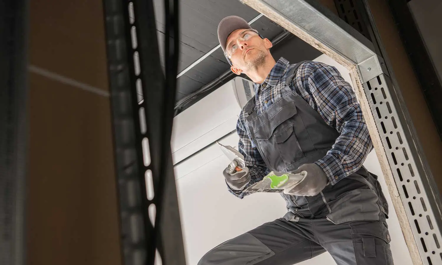 Home 2 A professional technician installing a garage door, demonstrating the expertise of a garage door marketing agency.