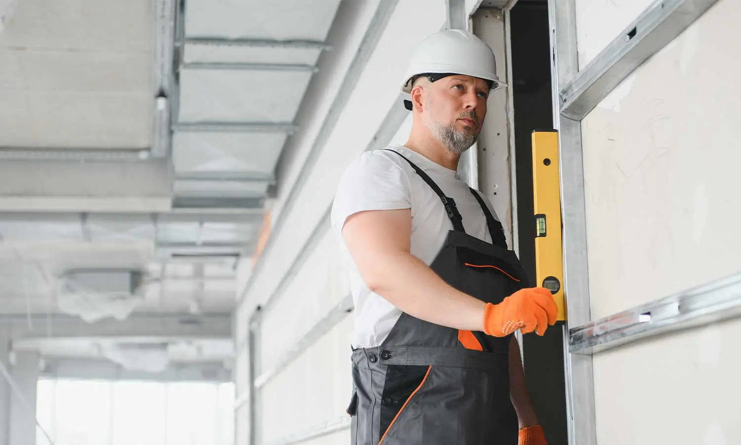 Home 3 A technician using a level to ensure proper garage door installation, showcasing the attention to detail valued by a garage door marketing agency