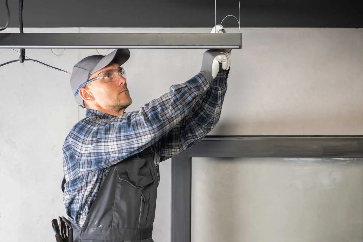 Experienced garage door repair professional completing installation with help from targeted garage door digital marketing services