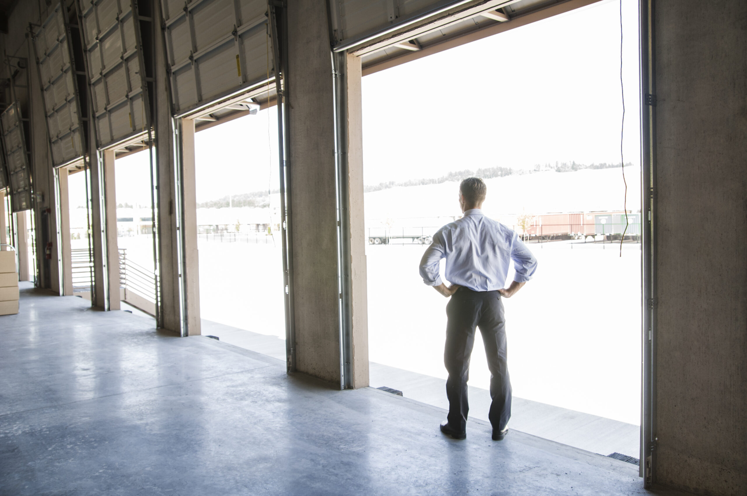 Photo of a business owner at a commercial garage site, ideal imagery for a garage door business plan or startup guide