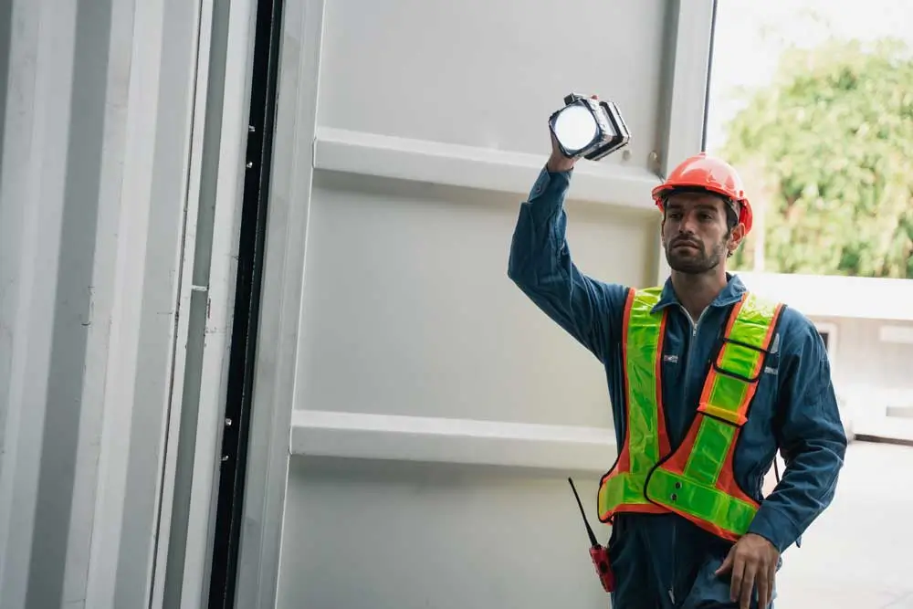 Garage contractor assessing commercial door hardware for a garage door repair ppc company project