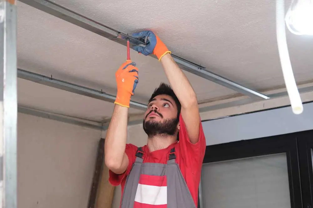 Garage Door Repair Ppc Services 2 Garage door repair contractor setting hardware for a client from garage door repair ppc services