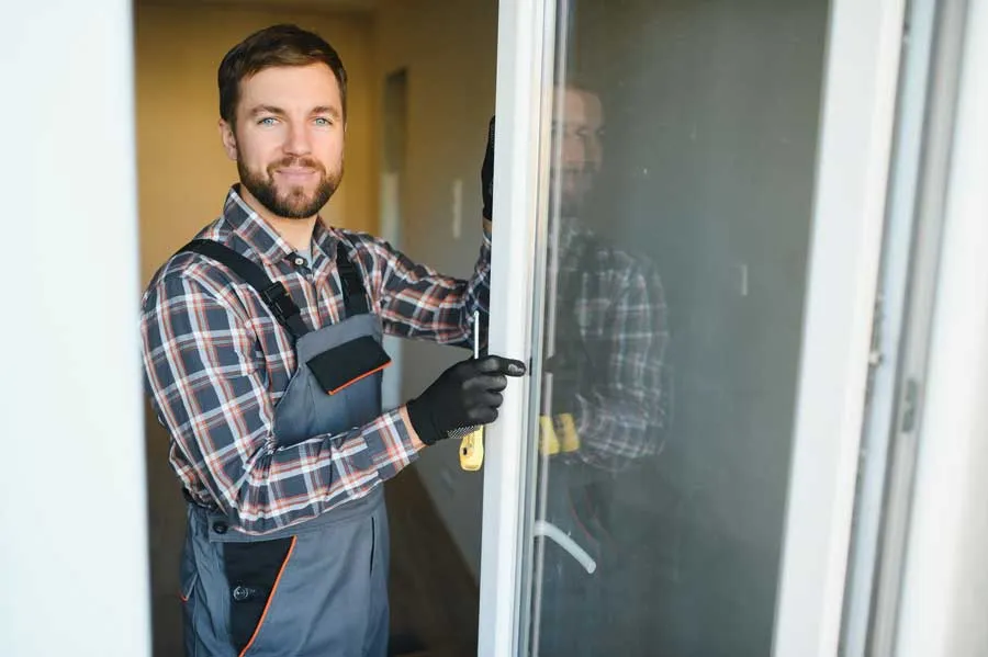 Young repairman adjusting a terrace door handle wi 2026 01 09 00 26 32 utc